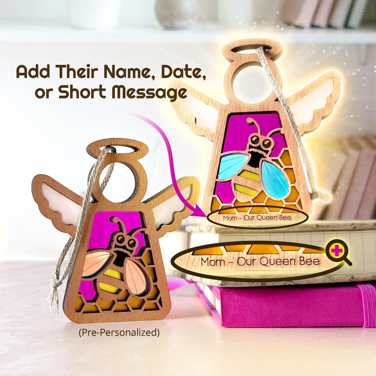 Personalized wooden angel-shaped ornaments with wings and a hanging string, shown in both uncustomized and customized views. The center panel features a colorful bee design with a pink background and stained-glass-style geometric outlines.