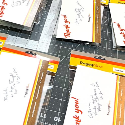 Collection of 'Thank you!' cards and decorative items on a cutting mat.