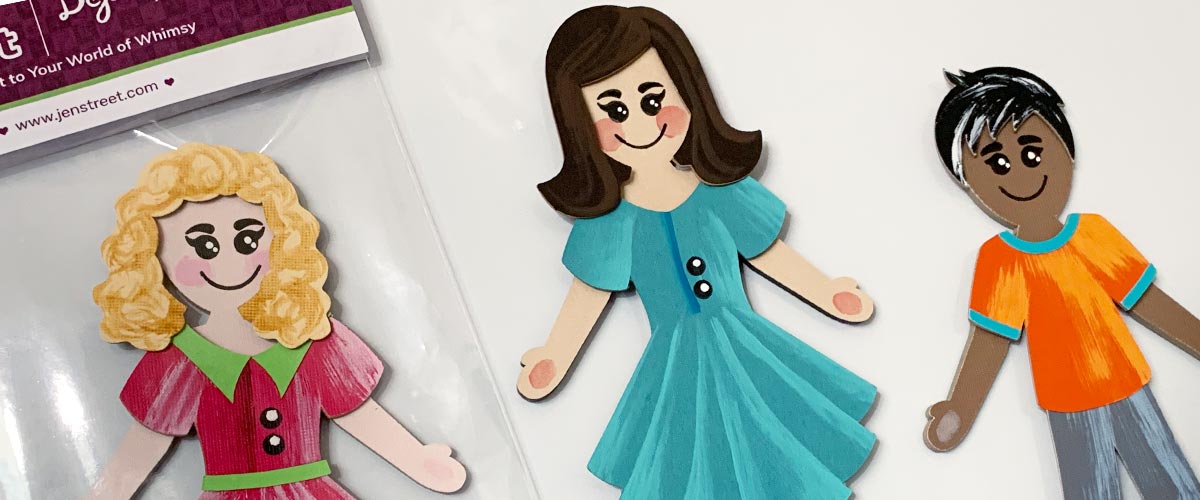 Cartoon-style paper dolls called Dejadoodles with different hairstyles and clothing on a white background