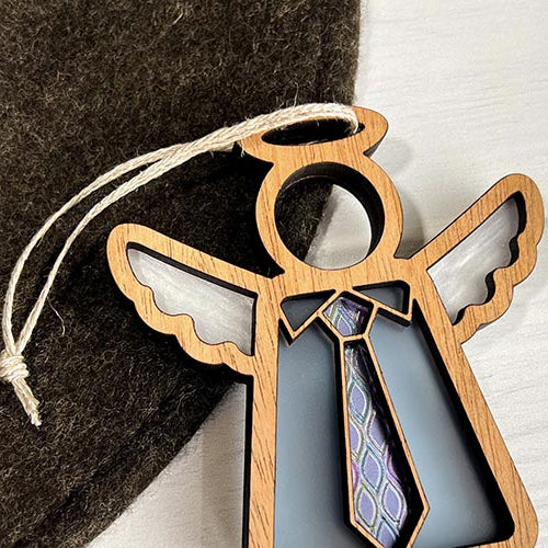 Decorative angel ornament with a blue background on a textured surface