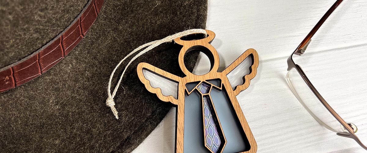 Decorative angel ornament with a blue background on a textured surface