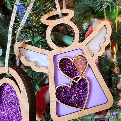 Forged Flare® angel figurines with purple hearts, displayed on a Christmas tree for a heartfelt holiday touch.