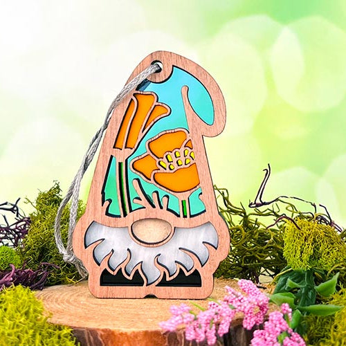 Forged Flare® California Poppy Gnome, a handcrafted gift idea for white elephant gift exchanges, featuring a vibrant orange poppy on a wooden stand with moss.