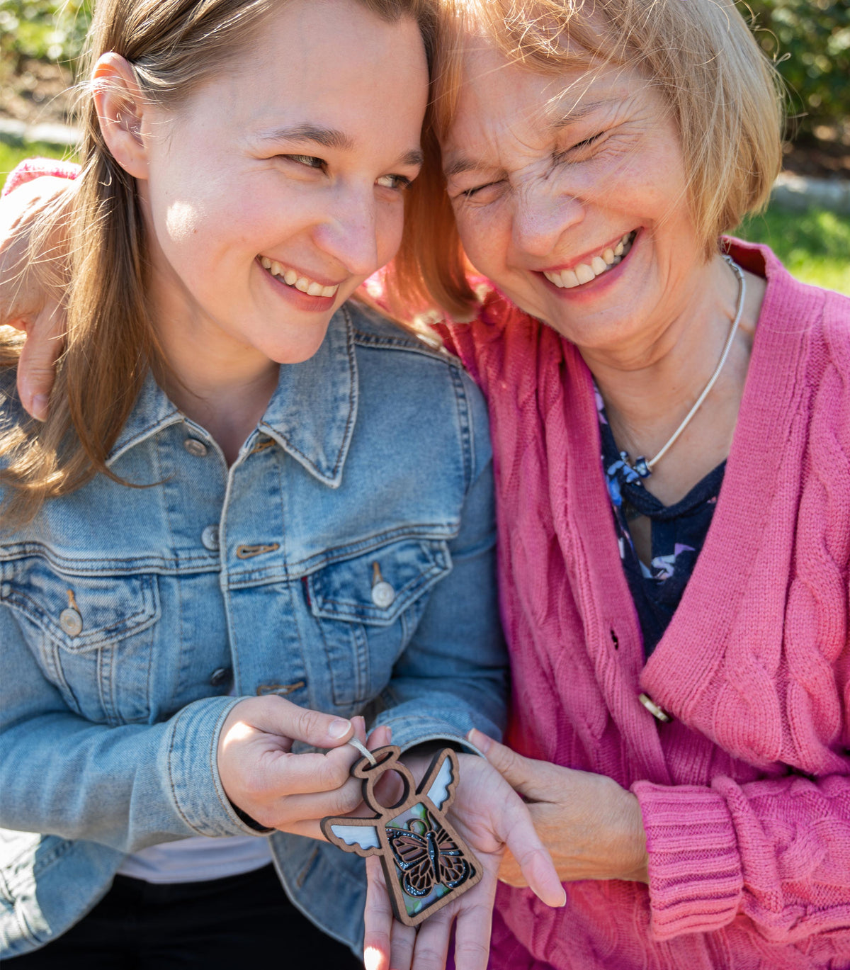 Smiling women holding a Mother’s Angels® Monarch Butterfly ornament, a heartfelt Valentine's Day gift for her, perfect for Galentine's Day and Valentine's Day tree decorations.