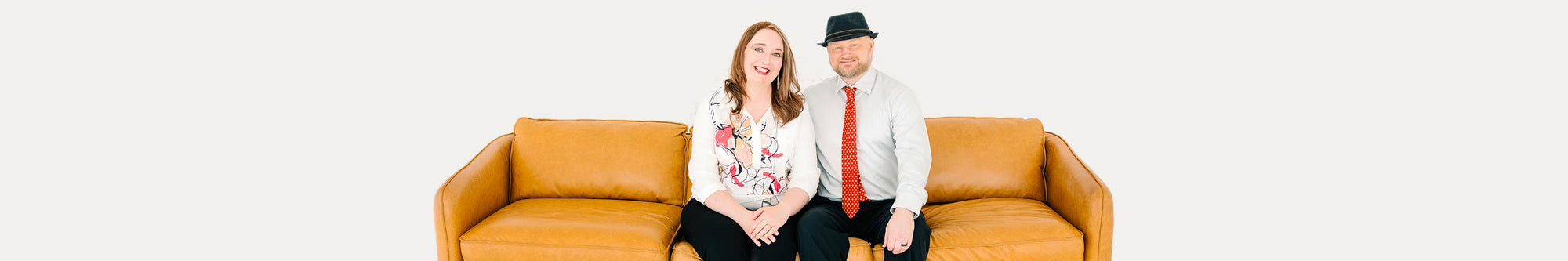Jen and Chris sitting on a sofa.