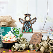 A Forged Flare® Lily of the Valley Ornament—Mother's Angels® 3.5" angel—hangs before a sprinkled cupcake birthday gift with gold ribbon, a “Happy Birthday” tag, lily of the valley accents, wrapping paper, and festive touches.