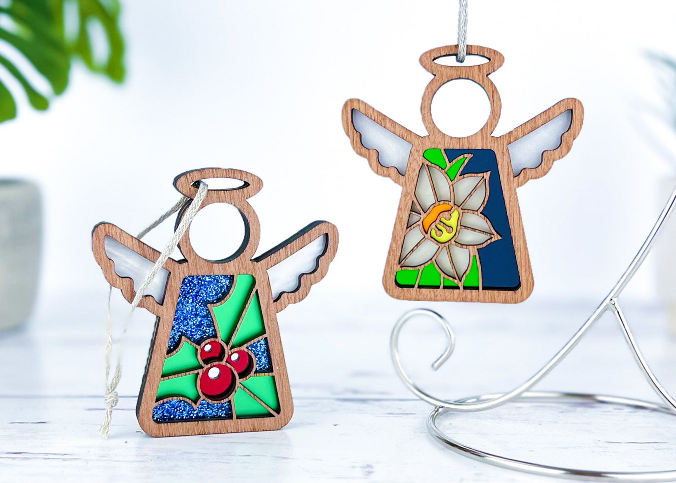 Angel ornaments featuring December birth month flowers, ideal birthday gift ideas for a wife, best friend or special women, showcasing vibrant holly and narcissus birth flowers in a stained glass inspired style.
