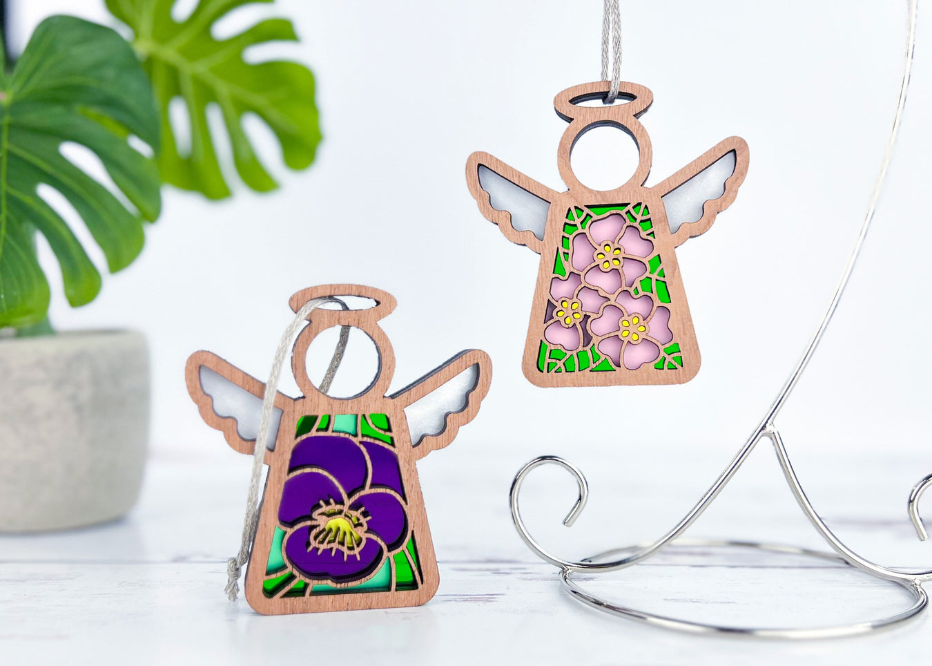 Angel ornaments featuring February birth month flowers, ideal birthday gift ideas for a wife, best friend or special women, showcasing vibrant primrose and violet birth flowers in a stained glass inspired style.
