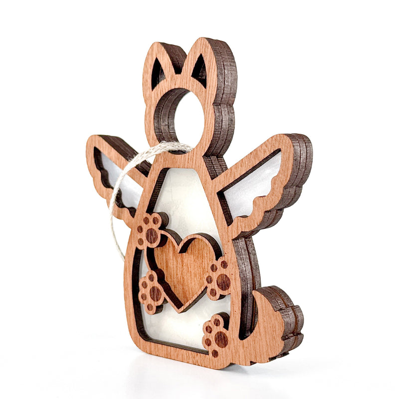 The Forever By My Side Dog Angel Ornament by Forged Flare® features a winged dog shape with paw prints, heart cutout, and twine loop. Layered wood and white accents make it a touching dog memorial or thoughtful gift for dog lovers.