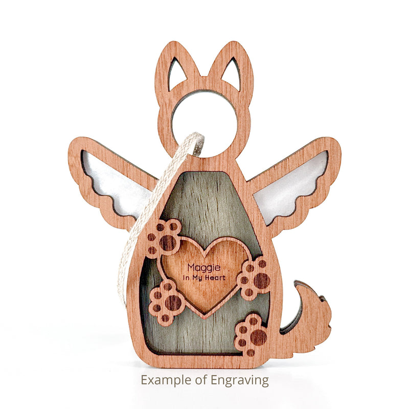 The Forged Flare® Forever By My Side Dog Angel Ornament features a wooden angel with wings, paw prints, and “Maggie In My Heart” engraving. Includes a hanging string—perfect personalized gift for dog lovers. Text reads "Example of Engraving".