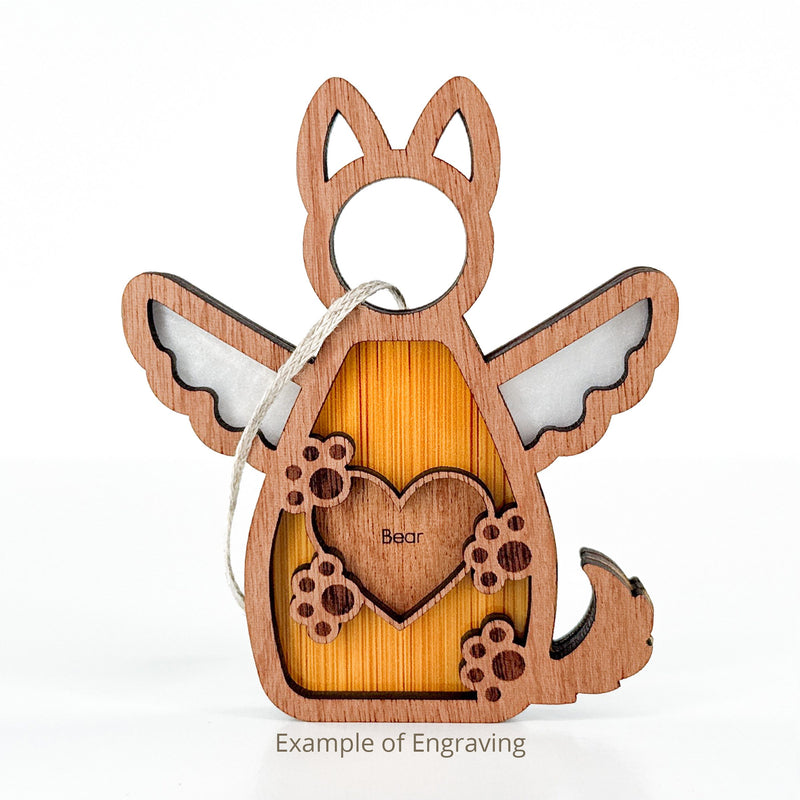 The Forged Flare® Forever By My Side Dog Angel Ornament is a wooden angel with dog ears, wings, tail, paw prints, and a "Bear" heart engraving. Includes string for hanging. Perfect for dog lovers. Text reads "Example of Engraving".