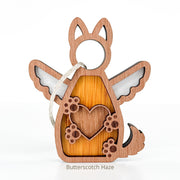The Forged Flare® Forever By My Side Dog Angel Ornament features a heart, paw prints, wings, and a hanging string—perfect as a dog lover or dog mom gift. Text reads "Butterscotch Haze".