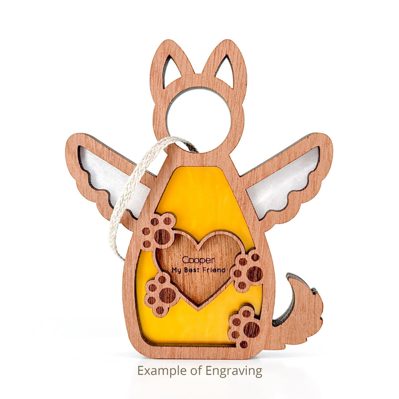 The Forged Flare® Forever By My Side Dog Angel Ornament features wings, a tail, pointed ears, and a yellow center with an engraved heart reading "Cooper My Best Friend." A thoughtful personalized memorial gift for dog lovers. Text reads "Example of Engraving".