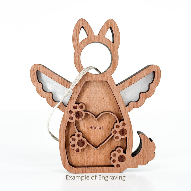 The Forged Flare® Forever By My Side Dog Angel Ornament features a wooden angel with wings, tail, and heart engraved with "Rocky" and paw prints. Ideal as a personalized dog ornament or memorial. String loop included for hanging. Text reads "Example of Engraving".