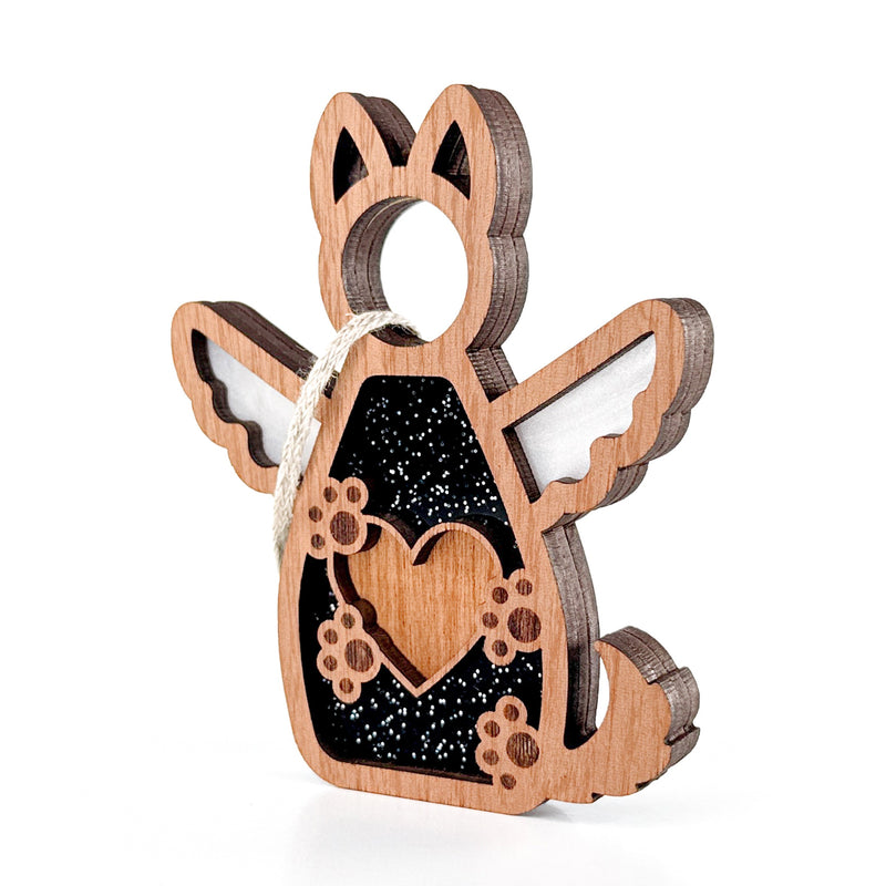 The Forged Flare® Forever By My Side Dog Angel Ornament features heart and paw cutouts, angel wings, a black glitter background, and a hanging loop—ideal as a dog lover gift or paired with personalized ornaments for pet memorials.