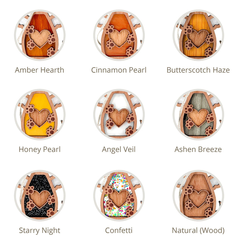 Nine honey-themed wood designs from Forged Flare®'s Forever In My Heart Dog Angel Ornament, each featuring a heart and labeled with their unique color options: Amber hearth, Cinnamon Pearl, Butterscotch Haze, Honey Pearl, Angel Veil, Ashen Breeze, Starry Night, Confetti, and Natural (Wood).