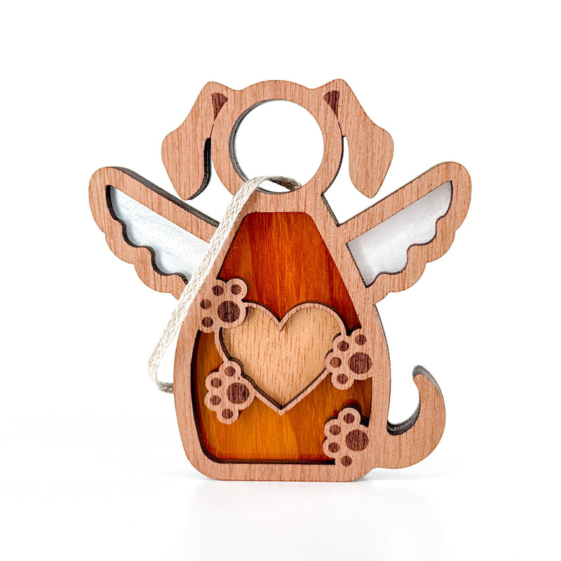 The Forged Flare® Forever In My Heart Dog Angel Ornament features wings, a heart, and paw prints in natural and wood, plus a hanging twine loop—perfect as a memorial or gift for dog lovers. 