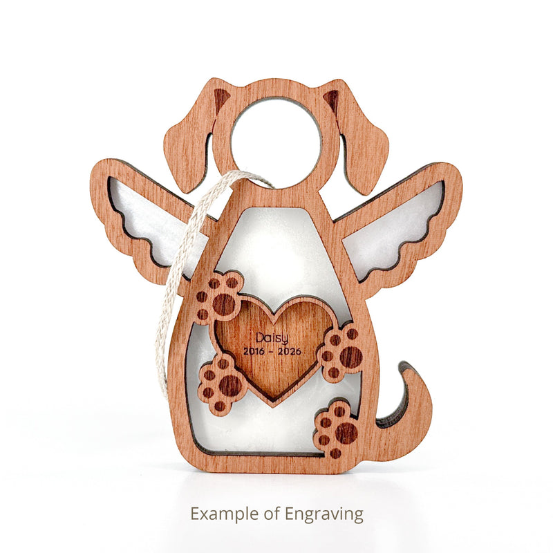 The Forged Flare® Forever In My Heart Dog Angel Ornament features a wooden dog with wings, paw prints, and a heart engraved with "Daisy 2016-2026." A perfect personalized dog mom or dog lover gift. Example engraving shown.