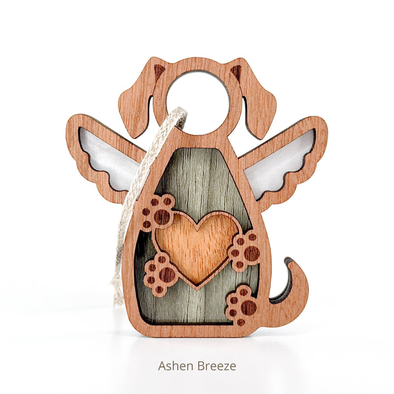 The Forever In My Heart Dog Angel Ornament by Forged Flare® is a rustic wooden angel with dog ears, wings, tail, and a heart with paw prints—complete with string loop. Perfect as a personalized dog lover gift or memorial. Text reads "Ashen Breeze".
