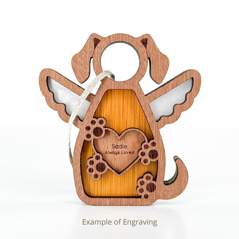 The Forged Flare® Forever In My Heart Dog Angel Ornament features a dog with wings, paw prints, a heart engraved "Sadie Always Loved," and a hanging string. A touching dog lover gift. Text reads "Example of Engraving".