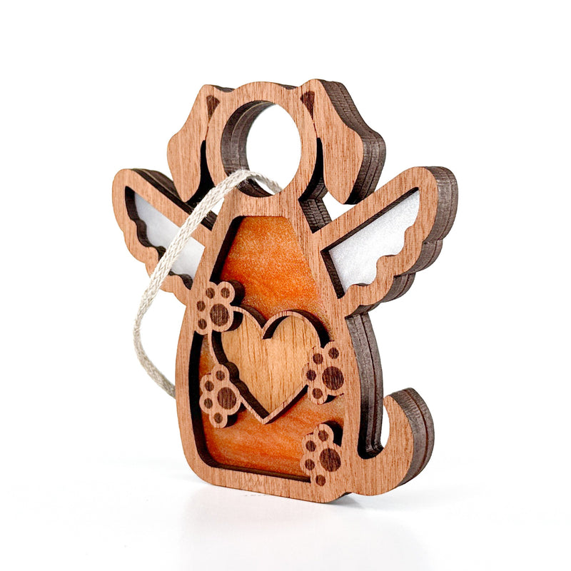The Forged Flare® Forever In My Heart Dog Angel Ornament is a brown and white wooden dog with angel wings, heart and paw print cutouts, and a hanging string—perfect as a personalized dog mom gift.