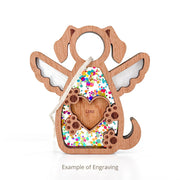 The Forever In My Heart Dog Angel Ornament by Forged Flare® features a dog-shaped angel with cut-out wings, a heart engraved with "Lola", colorful confetti inside, and a hanging string—perfect as a dog lover gift. Text reads "Example of Engraving".