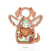 The Forged Flare® Forever In My Heart Dog Angel Ornament features a wooden dog shape with angel wings, a paw print, heart cutout, and confetti fill. Hanging by a string, it's ideal for dog lovers or as a heartfelt memorial. Text reads "Confetti".