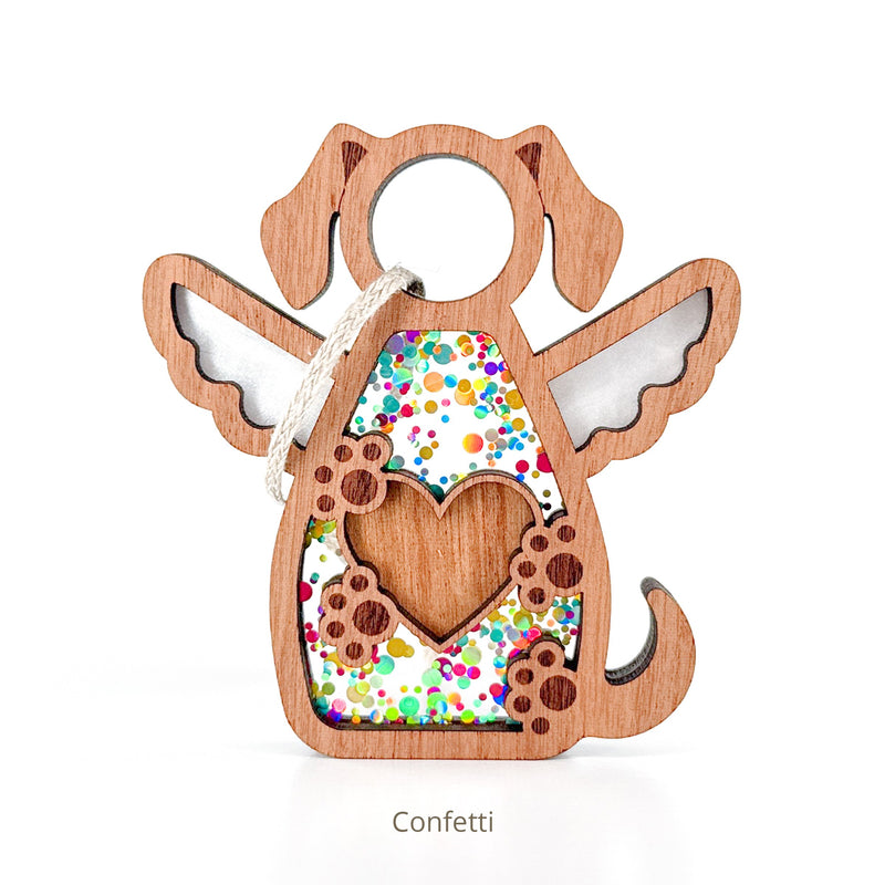 The Forged Flare® Forever In My Heart Dog Angel Ornament features a wooden dog shape with angel wings, a paw print, heart cutout, and confetti fill. Hanging by a string, it's ideal for dog lovers or as a heartfelt memorial. Text reads "Confetti".
