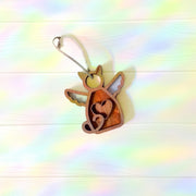 The Forged Flare® Forever Loved Cat Angel Ornament for Charity features heart cutouts and a hanging string, touched by pastel rainbow light—perfect as a custom cat ornament or thoughtful cat memorial.