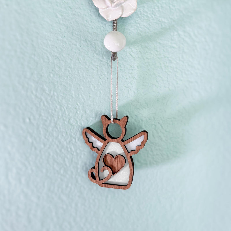 The Forged Flare® Forever Loved Cat Angel Ornament for Charity features a feline with wings and a heart cutout, hanging from a string—a meaningful memorial for any space.