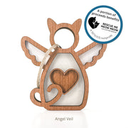 The Forever Loved Cat Angel Ornament for Charity by Forged Flare® is a wooden cat-shaped angel with wings, heart cutout, and rope loop. Includes sticker: "Proceeds benefit Rescue Me Meow Meow Cat & Kitten Rescue, a 501(c)(3) nonprofit.