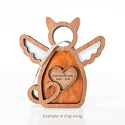 The Forged Flare® Forever Loved Cat Angel Ornament for Charity features a wooden cat-shaped design, heart engraving, twine loop for hanging, and is perfect as a custom cat memorial ornament. Text below shows “Example of Engraving.”.