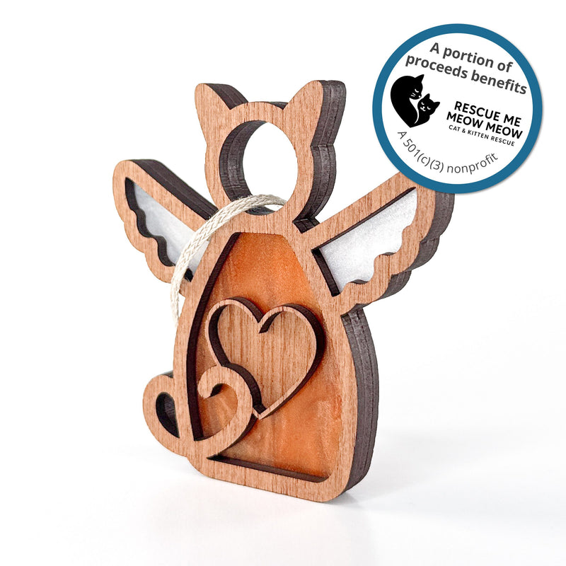 The Forged Flare® Forever Loved Cat Angel Ornament for Charity is a handcrafted wooden cat keepsake with wings, heart, white accents, and a hanging string. A blue sticker notes that proceeds benefit Rescue Me Meow Meow Cat & Kitten Rescue.
