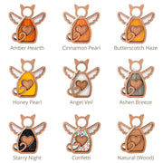 Nine Forever Loved Cat Angel Ornaments by Forged Flare® are shown, each with wings and a heart cutout in distinct colors like Amber Hearth, Cinnamon Pearl, and Butterscotch Haze—ideal as personalized pet ornaments or cat memorials.