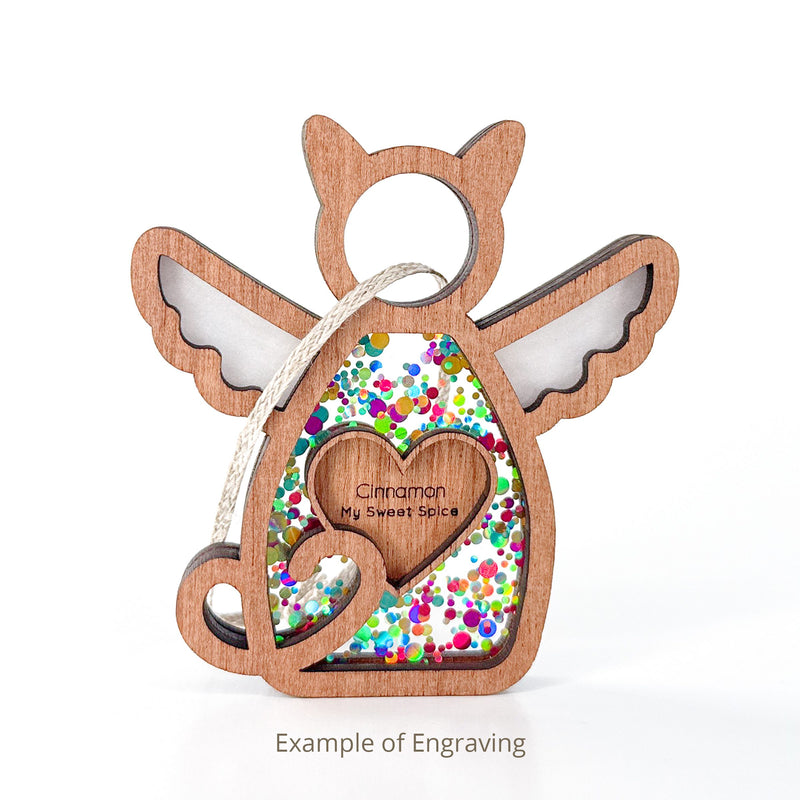 The Forever Loved Cat Angel Ornament for Charity by Forged Flare® is a cat-shaped wooden keepsake, engraved with “Cinnamon My Sweet Spice” and filled with colorful confetti—a heartfelt pet memorial or personalized ornament.