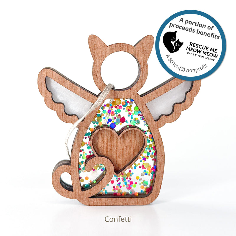 The Forged Flare® Forever Loved Cat Angel Ornament is a wooden cat-shaped ornament with wings, a heart cutout, and confetti. Proceeds help support RESCUE ME MEOW MEOW cat & kitten rescue. "Confetti" appears below the design.