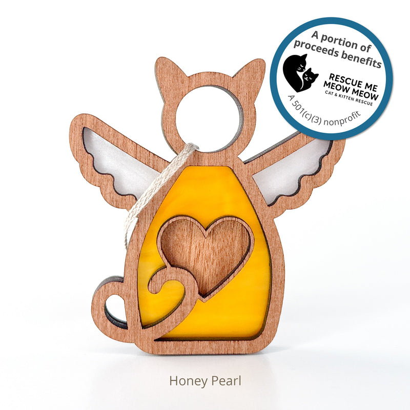 The Forever Loved Cat Angel Ornament for Charity by Forged Flare® features a wooden and yellow stained glass design with a heart cutout. A portion of proceeds supports the Rescue Me Meow cat and kitten nonprofit.