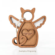 The Forged Flare® Forever Loved Cat Angel Ornament for Charity features angel wings, a halo, an engraved heart ("Widget Street 2007 – 2025"), a hanging string, and "Example of Engraving" text—perfect as a cat memorial.