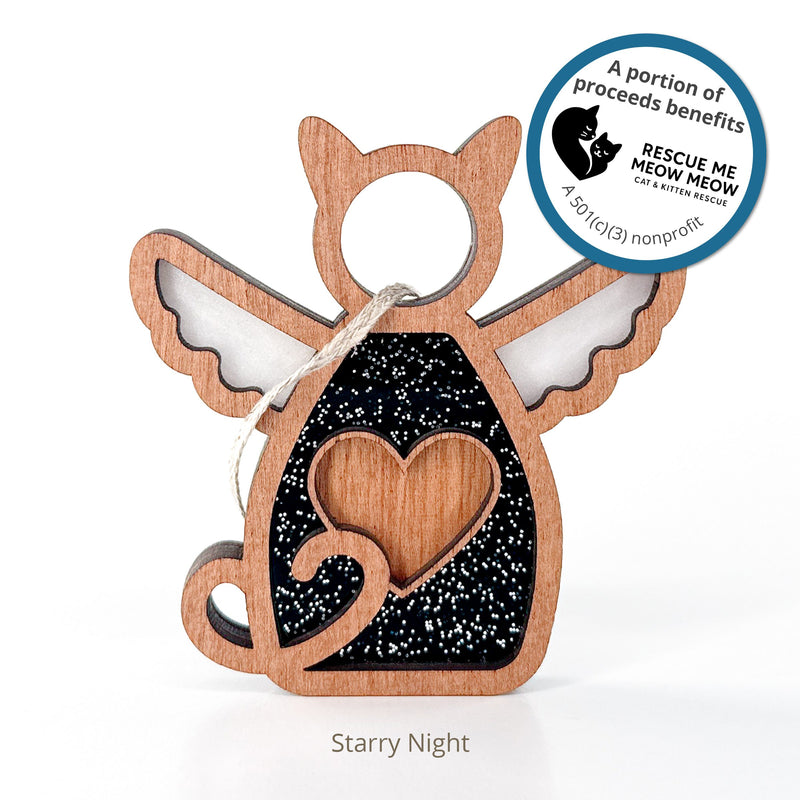 The Forged Flare® Forever Loved Cat Angel Ornament features a wooden cat with angel wings, heart cut-out, and black glittery background. "A portion of proceeds benefits Rescue Me Meow Meow." Below reads: "Starry Night.
