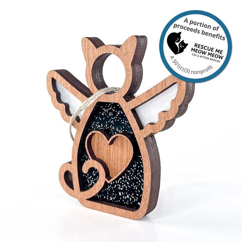 The Forged Flare® Forever Loved Cat Angel Ornament features a winged cat with heart cutout. A portion of proceeds supports Rescue Me Meow Meow, a cat rescue. Ideal as a personalized keepsake or memorial gift for any cat lover.