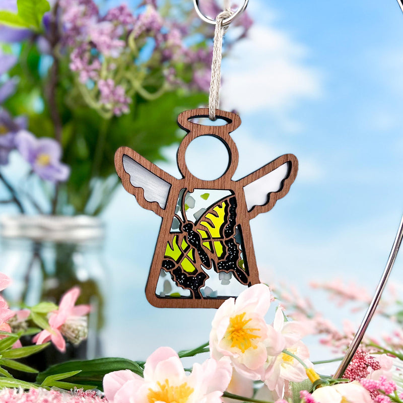 The Forged Flare® Mother's Angels® 3.5" Swallowtail Butterfly Ornament features a wooden angel with a yellow and black butterfly motif—ideal for brightening any space and available as a Warehouse Return on Amazon.