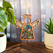 The Forged Flare® Mother’s Angels® Dragonfly Ornament, a 3.5" wooden angel figurine with stained glass wings, is available as a warehouse return on Amazon—perfect for displaying indoors with potted plants and soft curtains.