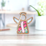 The Forged Flare® Mother's Angels® 3.5" Breast Cancer Awareness Ribbon for Charity Ornament features a stained-glass angel and pink ribbon—a heartfelt gift to honor survivors during Breast Cancer Awareness Month.