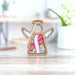 A pink ribbon-decorated ornament, ideal for Breast Cancer Awareness Month, symbolizing support for survivors and patients.