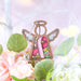 Surrounded by delicate flowers, this angel ornament with a pink ribbon is a heartfelt gift to inspire breast cancer awareness. October is Breast Cancer Awareness Month