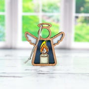 The Burning Candle Ornament by Forged Flare® is a 3.5" Mother's Angels® figurine with a silver string, ideal for your angel collection or as a Christmas or memorial gift. Its stained glass candle design shines beautifully by any window.