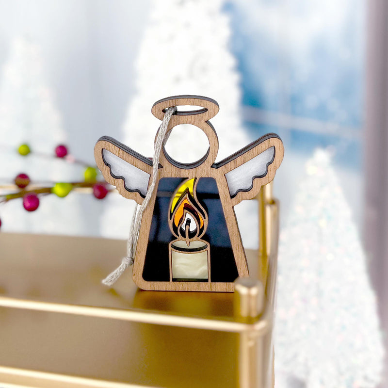 An intricately designed Christmas tree ornament, featuring a graceful angel with a burning candle, ideal for Christmas decor.