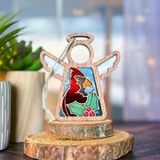 The Forged Flare® Mother's Angels® Winter Cardinal Ornament is a 3.5" handcrafted angel figurine with stained glass, cardinal, and holly leaves—an exquisite collectible centerpiece for your décor, even with its unique imperfections.