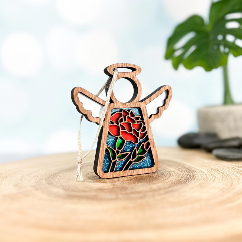The Forged Flare® Carnation Ornament | 3.5" (H) Angel Figurine from Mother's Angels® features stained-glass style carnations—April’s birth flower—in a wooden angel with cutout wings and halo, ready to hang.