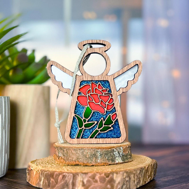A beautifully detailed angel ornament with a red carnation flower, ideal for January birthdays and unique gifts for her.